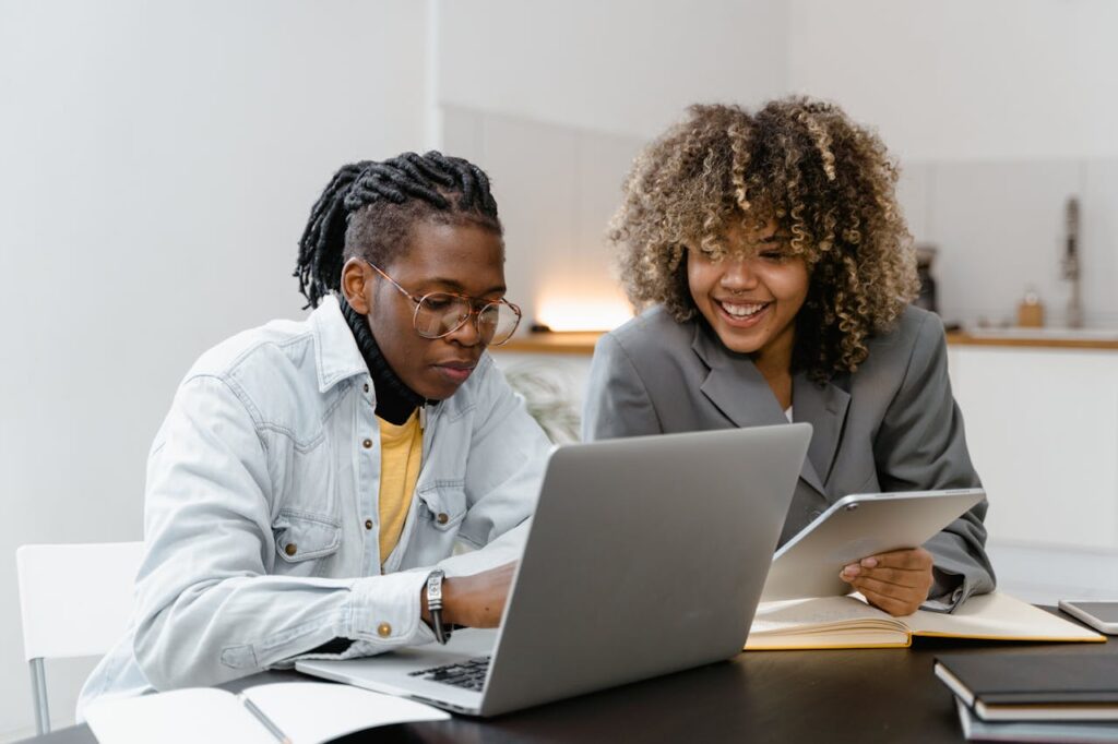 Two people discussing an idea on the laptop